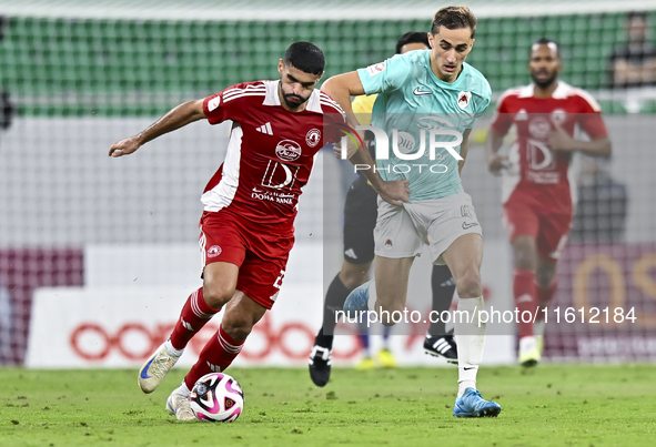 Julien De Sart (R) of Al Rayyan SC battles for the ball with Alaaeddin Mohammed Hasan (L) of Al Arabi SC during the Ooredoo Qatar Stars Leag...