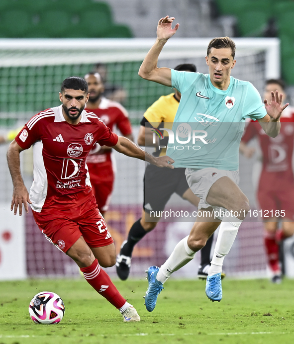 Julien De Sart (R) of Al Rayyan SC battles for the ball with Alaaeddin Mohammed Hasan (L) of Al Arabi SC during the Ooredoo Qatar Stars Leag...