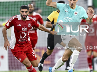 Julien De Sart (R) of Al Rayyan SC battles for the ball with Alaaeddin Mohammed Hasan (L) of Al Arabi SC during the Ooredoo Qatar Stars Leag...