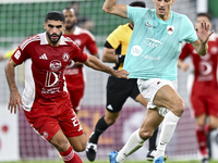 Julien De Sart (R) of Al Rayyan SC battles for the ball with Alaaeddin Mohammed Hasan (L) of Al Arabi SC during the Ooredoo Qatar Stars Leag...