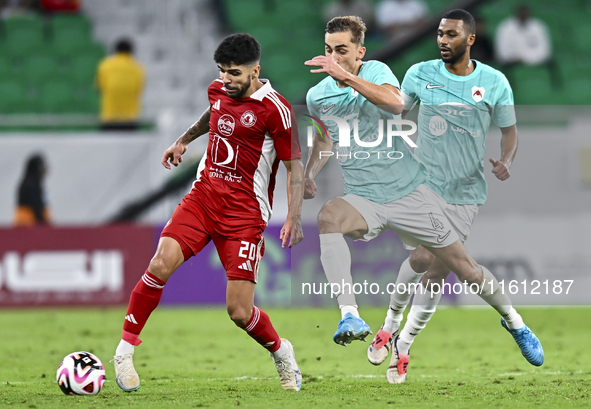 Julien De Sart (R) of Al Rayyan SC battles for the ball with Luiz Martin Junior (L) of Al Arabi SC during the Ooredoo Qatar Stars League 24/...