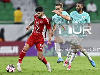 Julien De Sart (R) of Al Rayyan SC battles for the ball with Luiz Martin Junior (L) of Al Arabi SC during the Ooredoo Qatar Stars League 24/...