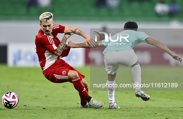 Ahmed Albakheet Al-Minhal (R) of Al Rayyan SC battles for the ball with Rodriguez Sanchez Rodrigo (L) of Al Arabi SC during the Ooredoo Qata...