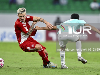 Ahmed Albakheet Al-Minhal (R) of Al Rayyan SC battles for the ball with Rodriguez Sanchez Rodrigo (L) of Al Arabi SC during the Ooredoo Qata...