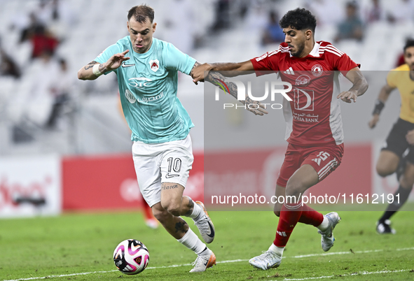 Roger Krug Guedes (L) of Al Rayyan SC battles for the ball with Jassem Gaber Abdulsallam (R) of Al Arabi SC during the Ooredoo Qatar Stars L...