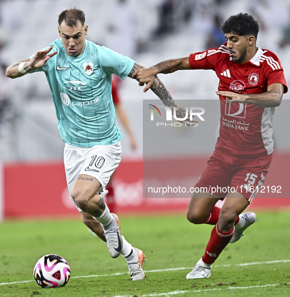 Roger Krug Guedes (L) of Al Rayyan SC battles for the ball with Jassem Gaber Abdulsallam (R) of Al Arabi SC during the Ooredoo Qatar Stars L...