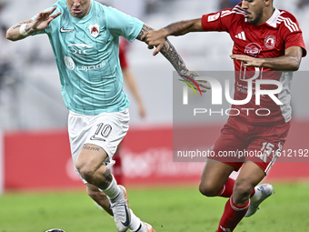 Roger Krug Guedes (L) of Al Rayyan SC battles for the ball with Jassem Gaber Abdulsallam (R) of Al Arabi SC during the Ooredoo Qatar Stars L...