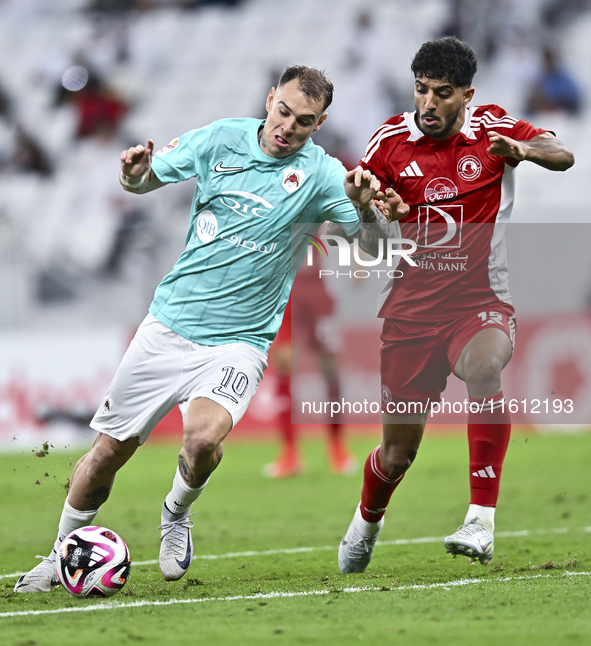 Roger Krug Guedes (L) of Al Rayyan SC battles for the ball with Jassem Gaber Abdulsallam (R) of Al Arabi SC during the Ooredoo Qatar Stars L...