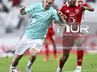 Roger Krug Guedes (L) of Al Rayyan SC battles for the ball with Jassem Gaber Abdulsallam (R) of Al Arabi SC during the Ooredoo Qatar Stars L...