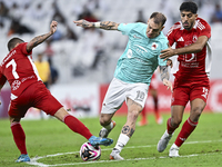 Roger Krug Guedes (R) of Al Rayyan SC battles for the ball with Jassem Gaber Abdulsallam (C) of Al Arabi SC during the Ooredoo Qatar Stars L...