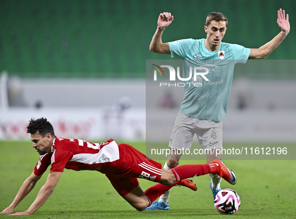 Julien De Sart (R) of Al Rayyan SC battles for the ball with Youssef Msakni (L) of Al Arabi SC during the Ooredoo Qatar Stars League 24/25 m...