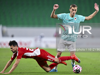 Julien De Sart (R) of Al Rayyan SC battles for the ball with Youssef Msakni (L) of Al Arabi SC during the Ooredoo Qatar Stars League 24/25 m...