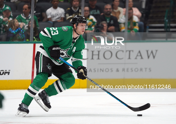 Esa Lindell #23 of the Dallas Stars skates up the ice while controlling the puck during the NHL preseason match between the Dallas Stars and...