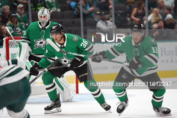 Luke Krys #36 and Logan Stankoven #11 of the Dallas Stars skate up the ice while defending the goal during the NHL preseason match between t...