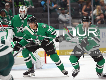 Luke Krys #36 and Logan Stankoven #11 of the Dallas Stars skate up the ice while defending the goal during the NHL preseason match between t...