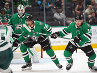 Luke Krys #36 and Logan Stankoven #11 of the Dallas Stars skate up the ice while defending the goal during the NHL preseason match between t...