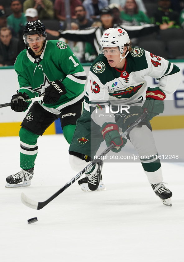 Hunter Haight #43 of Minnesota Wild skates with control of the puck while defended by Logan Stankoven #11 of Dallas Stars during the NHL pre...