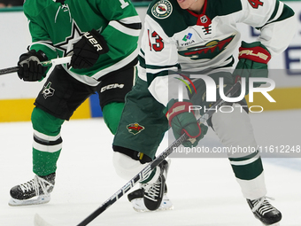 Hunter Haight #43 of Minnesota Wild skates with control of the puck while defended by Logan Stankoven #11 of Dallas Stars during the NHL pre...