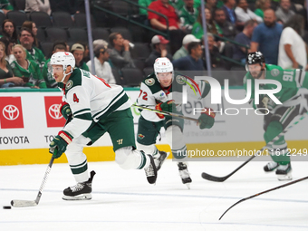 Jon Merril #4 of the Minnesota Wild controls the puck during the NHL preseason match between the Dallas Stars and the Minnesota Wild at Amer...