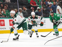 Jon Merril #4 of the Minnesota Wild controls the puck during the NHL preseason match between the Dallas Stars and the Minnesota Wild at Amer...