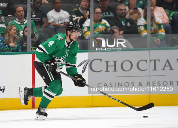 Miro Heiskanen #4 of the Dallas Stars skates up the ice while controlling the puck during the NHL preseason match between the Dallas Stars a...