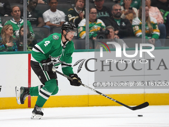 Miro Heiskanen #4 of the Dallas Stars skates up the ice while controlling the puck during the NHL preseason match between the Dallas Stars a...