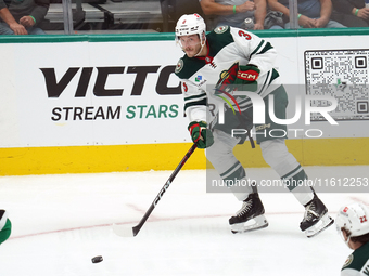 Joseph Cecconi #3 of the Minnesota Wild skates up the ice while controlling the puck during the NHL preseason match between the Dallas Stars...