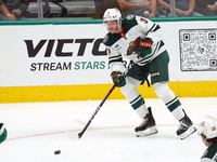 Joseph Cecconi #3 of the Minnesota Wild skates up the ice while controlling the puck during the NHL preseason match between the Dallas Stars...