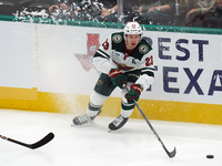 Marco Rossi #23 of the Minnesota Wild skates up the ice while controlling the puck during the NHL preseason match between the Dallas Stars a...