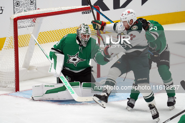 Jake Oettinger #29 of the Dallas Stars makes a save against Travis Boyd #72 of the Minnesota Wild during the NHL preseason match between the...