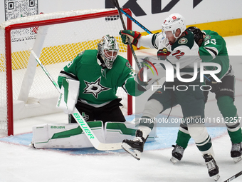 Jake Oettinger #29 of the Dallas Stars makes a save against Travis Boyd #72 of the Minnesota Wild during the NHL preseason match between the...