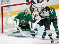 Jake Oettinger #29 of the Dallas Stars makes a save against Travis Boyd #72 of the Minnesota Wild during the NHL preseason match between the...