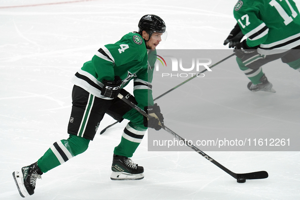 Miro Heiskanen #4 of the Dallas Stars skates up the ice while controlling the puck during the NHL preseason match between the Dallas Stars a...