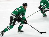 Miro Heiskanen #4 of the Dallas Stars skates up the ice while controlling the puck during the NHL preseason match between the Dallas Stars a...