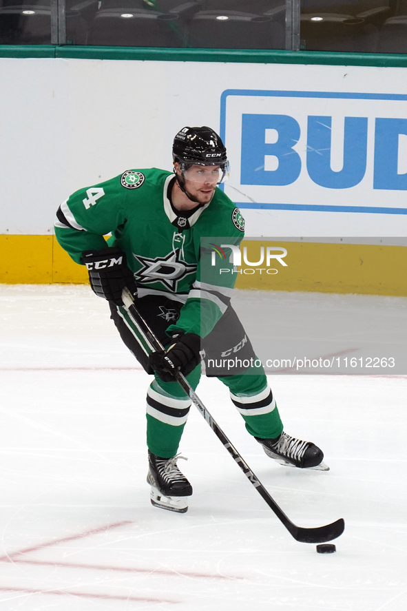 Miro Heiskanen #4 of the Dallas Stars skates up the ice while controlling the puck during the NHL preseason match between the Dallas Stars a...