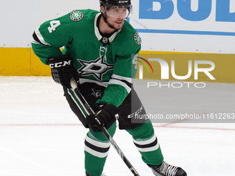 Miro Heiskanen #4 of the Dallas Stars skates up the ice while controlling the puck during the NHL preseason match between the Dallas Stars a...