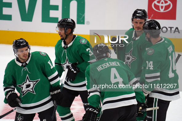 Dallas Stars players gather on the ice during the NHL preseason match between the Dallas Stars and the Minnesota Wild at American Airlines C...