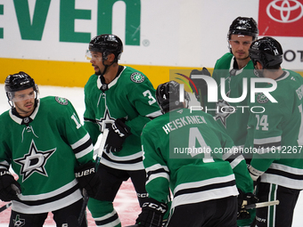 Dallas Stars players gather on the ice during the NHL preseason match between the Dallas Stars and the Minnesota Wild at American Airlines C...