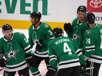 Dallas Stars players gather on the ice during the NHL preseason match between the Dallas Stars and the Minnesota Wild at American Airlines C...