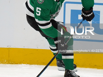 Nils Lundkvist #5 of the Dallas Stars skates up the ice while controlling the puck during the NHL preseason match between the Dallas Stars a...