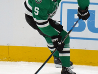 Nils Lundkvist #5 of the Dallas Stars skates up the ice while controlling the puck during the NHL preseason match between the Dallas Stars a...