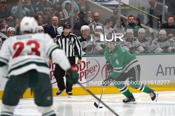 Miro Heiskanen #4 of the Dallas Stars controls the puck during the NHL preseason match between the Dallas Stars and the Minnesota Wild at Am...