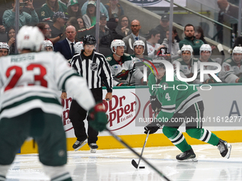 Miro Heiskanen #4 of the Dallas Stars controls the puck during the NHL preseason match between the Dallas Stars and the Minnesota Wild at Am...