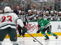 Miro Heiskanen #4 of the Dallas Stars controls the puck during the NHL preseason match between the Dallas Stars and the Minnesota Wild at Am...