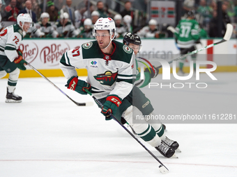 Declan Chisholm #47 of the Minnesota Wild controls the puck during the NHL preseason match between the Dallas Stars and the Minnesota Wild a...