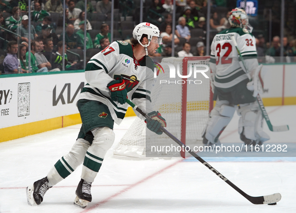 Declan Chisholm #47 of the Minnesota Wild controls the puck during the NHL preseason match between the Dallas Stars and the Minnesota Wild a...