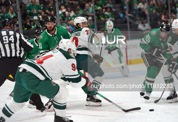 Marat Khusnutdinov #22 of the Minnesota Wild plays the puck during the NHL preseason match between the Dallas Stars and the Minnesota Wild a...