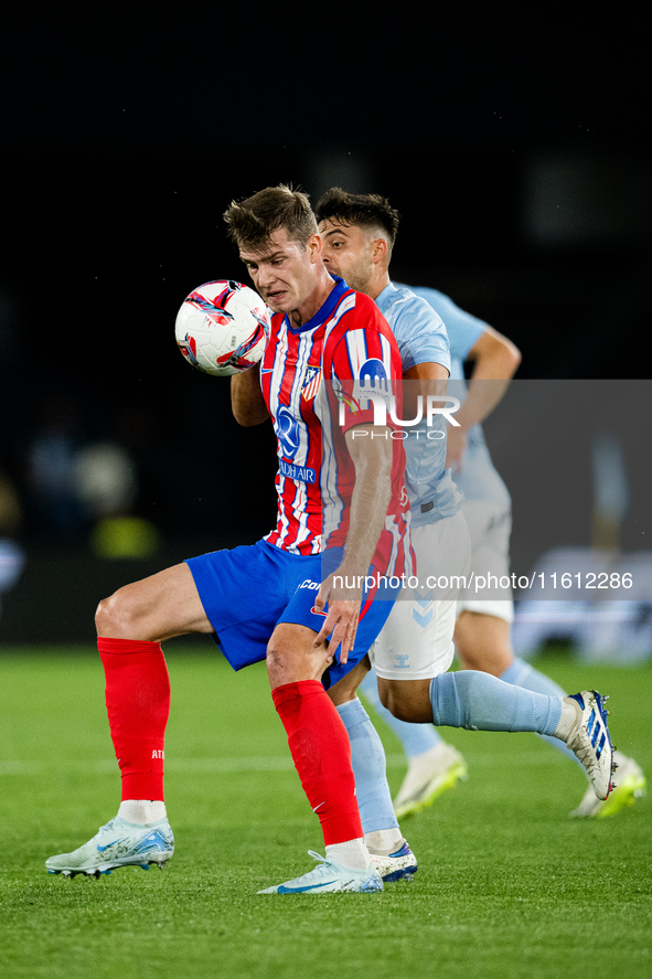 Alexander Sorloth (L) of Atletico de Madrid fights for the ball with Fran Beltran (R) of RC Celta de Vigo during the LaLIGA EA SPORTS match...