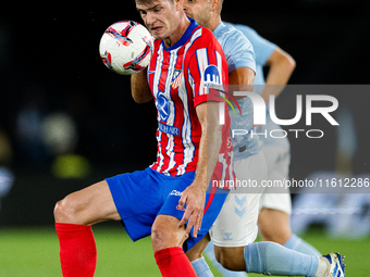 Alexander Sorloth (L) of Atletico de Madrid fights for the ball with Fran Beltran (R) of RC Celta de Vigo during the LaLIGA EA SPORTS match...