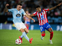 Iago Aspas (L) of RC Celta de Vigo fights for the ball with Reinildo Mandava (R) of Atletico de Madrid during the LaLIGA EA SPORTS match bet...